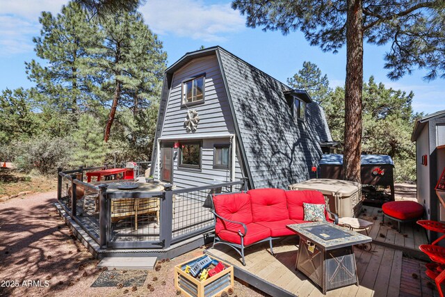 4872 N Trails End Dr, Pine, AZ 85544 - back of property featuring a deck, outdoor dining space, an outdoor living space, a gambrel roof, and roof with shingles