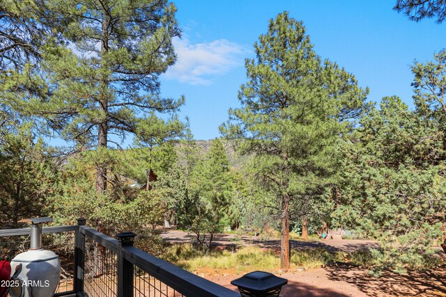 4872 N Trails End Dr, Pine, AZ 85544 - wooden deck featuring a wooded view