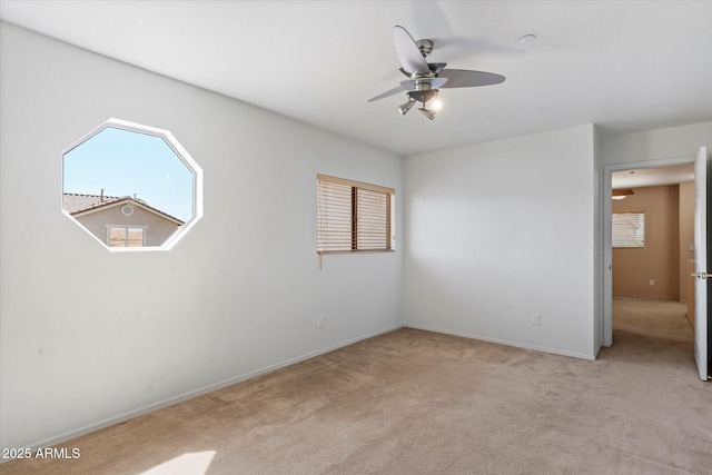 7500 E Deer Valley Rd Unit 54, Scottsdale, AZ 85255 - spare room with light colored carpet, a ceiling fan, and baseboards