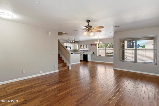7500 E Deer Valley Rd Unit 54, Scottsdale, AZ 85255 - unfurnished living room featuring a chandelier, a ceiling fan, baseboards, dark wood-style flooring, and stairs