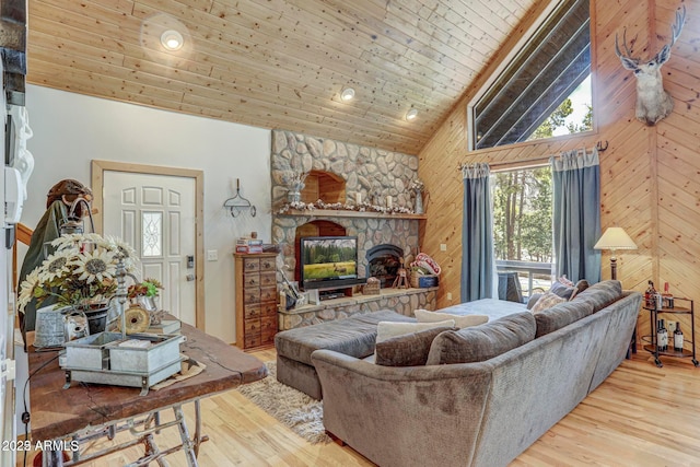 6124 W Hidden Pines Loop, Pine, AZ 85544 - living area featuring wood finished floors, high vaulted ceiling, wooden walls, a fireplace, and wooden ceiling