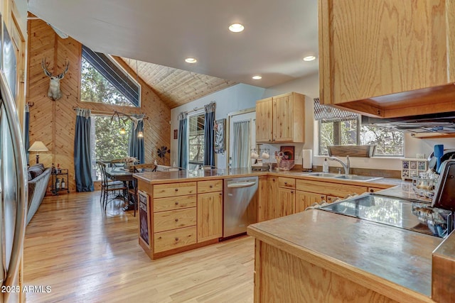6124 W Hidden Pines Loop, Pine, AZ 85544 - kitchen with light brown cabinets, stainless steel appliances, a peninsula, light wood-style flooring, and wood walls