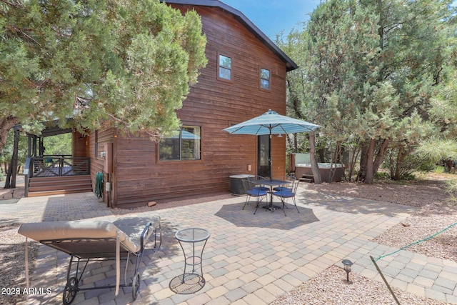6124 W Hidden Pines Loop, Pine, AZ 85544 - view of patio / terrace with a hot tub and outdoor dining space