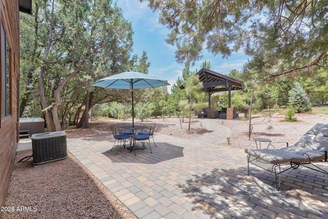 6124 W Hidden Pines Loop, Pine, AZ 85544 - view of patio with a hot tub, a gazebo, and outdoor lounge area