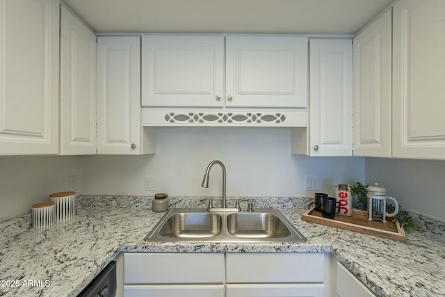 kitchen with dishwasher, sink, and white cabinets