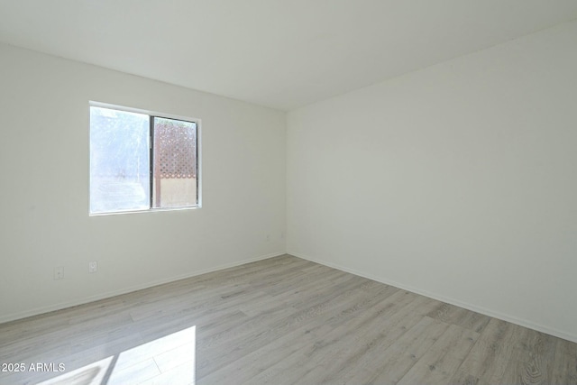 spare room featuring light wood-type flooring