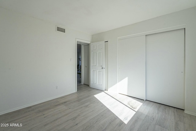 unfurnished bedroom featuring light wood-type flooring