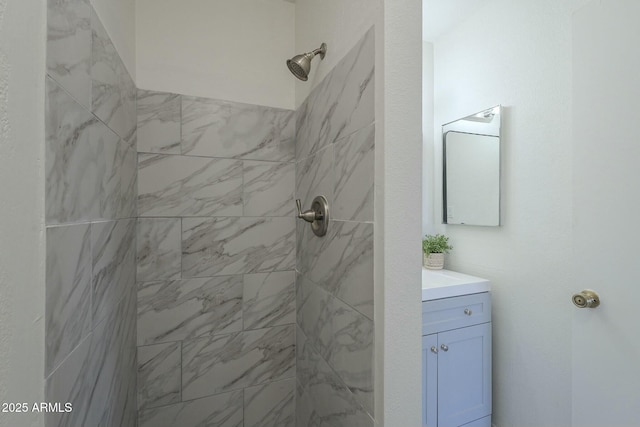 bathroom featuring vanity and a tile shower