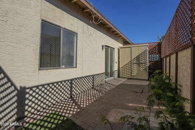 view of side of home with a patio area