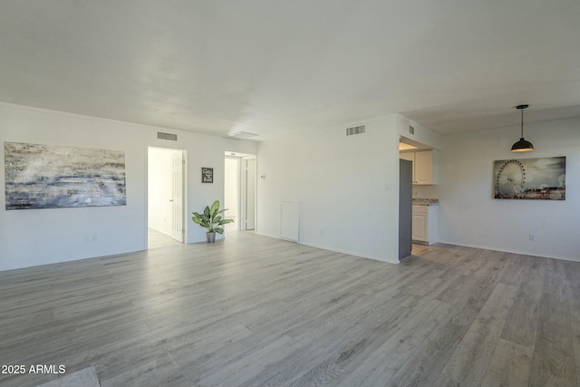 unfurnished living room featuring light hardwood / wood-style flooring