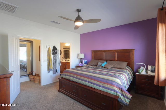 bedroom featuring ensuite bathroom, ceiling fan, and light colored carpet