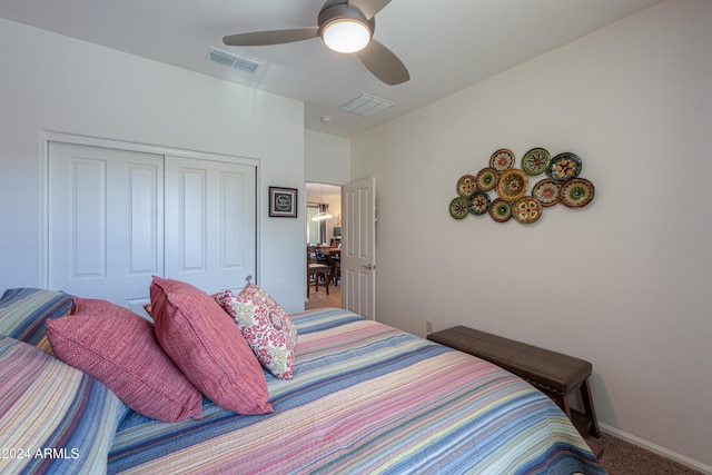 carpeted bedroom with ceiling fan and a closet