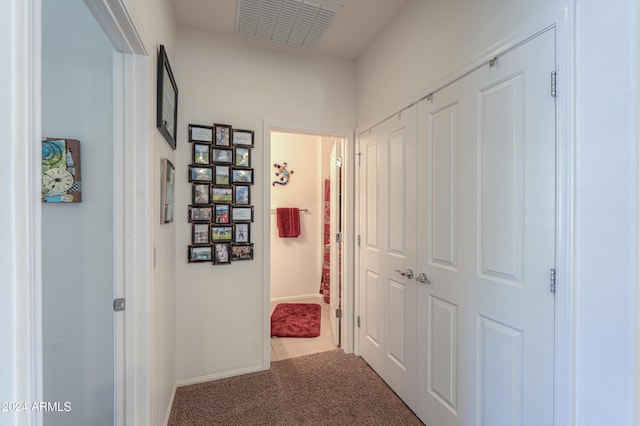 hallway with carpet floors