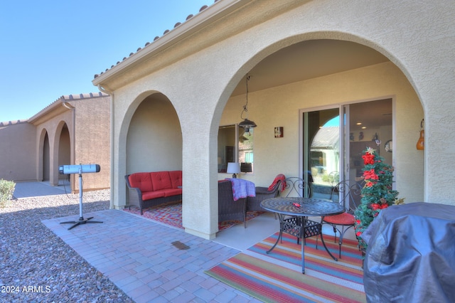 view of patio with area for grilling and an outdoor living space