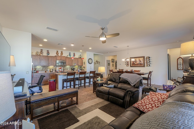 carpeted living room featuring ceiling fan