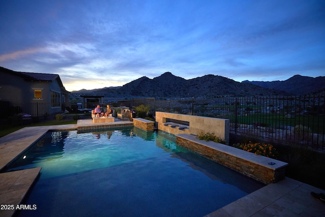 view of swimming pool featuring a fenced in pool, a mountain view, a patio, and fence