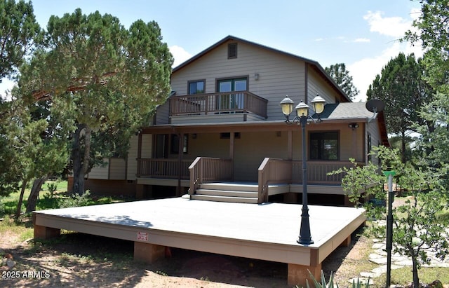 back of property with a balcony
