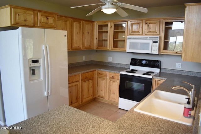 kitchen with a sink, glass insert cabinets, light tile patterned floors, white appliances, and ceiling fan