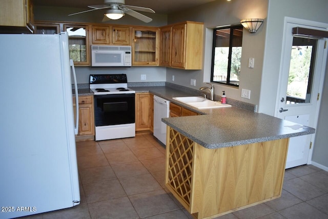 kitchen with tile patterned flooring, white appliances, a sink, a ceiling fan, and a peninsula