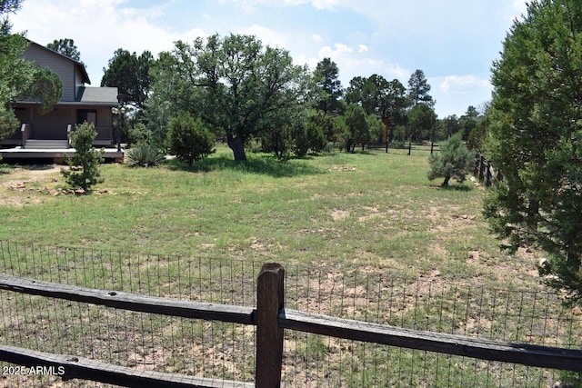 view of yard with fence and a wooden deck
