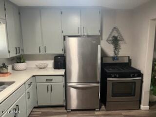 kitchen with white cabinetry and appliances with stainless steel finishes