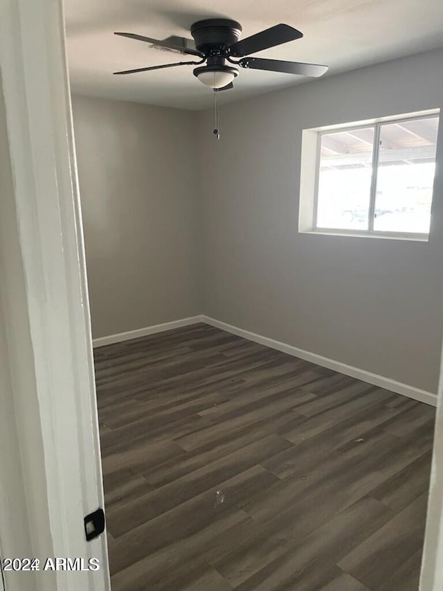 unfurnished room with ceiling fan and dark hardwood / wood-style floors