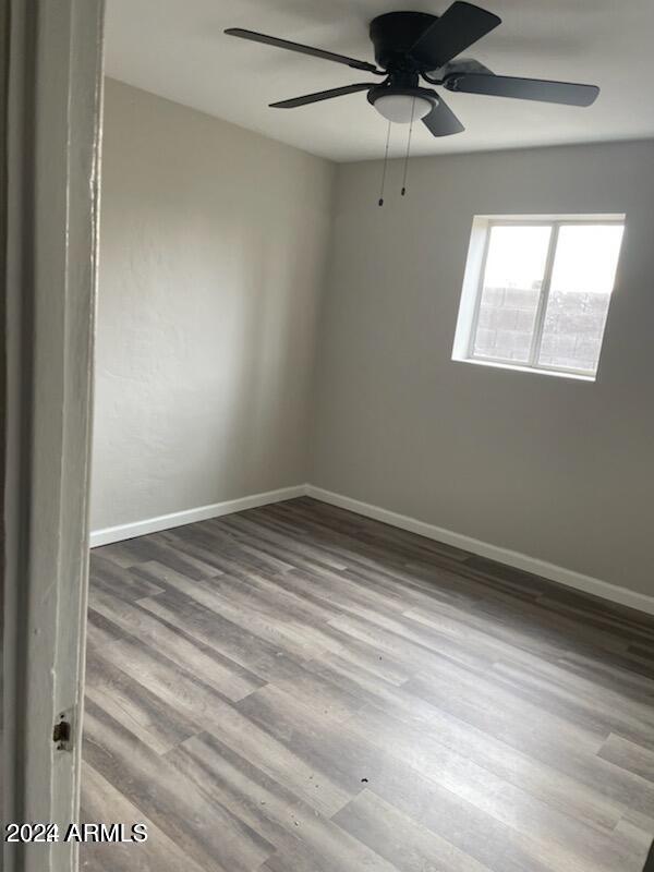 empty room featuring hardwood / wood-style floors and ceiling fan