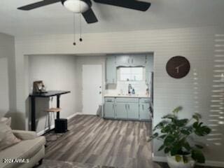 living room featuring ceiling fan and wood-type flooring