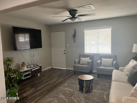 living room with ceiling fan and dark hardwood / wood-style flooring