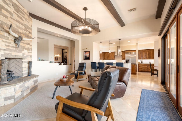 living room with beam ceiling, light tile patterned floors, and a fireplace