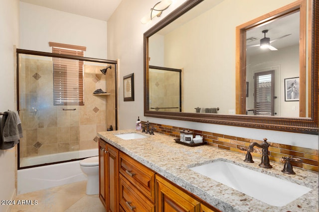 full bathroom featuring toilet, enclosed tub / shower combo, vanity, decorative backsplash, and tile patterned flooring