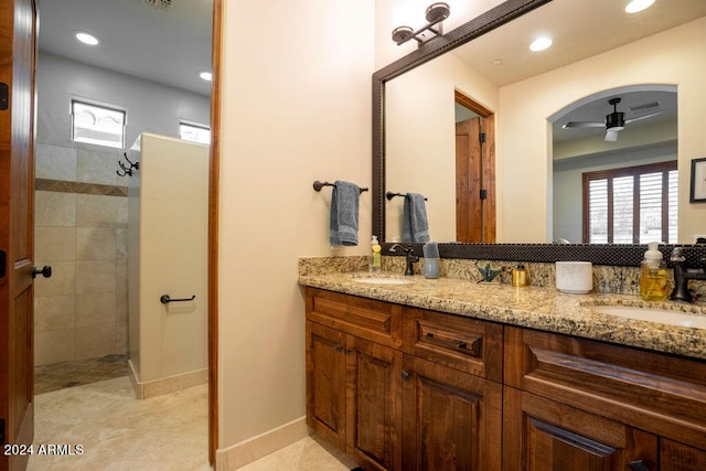 bathroom with vanity, tile patterned floors, a tile shower, and ceiling fan