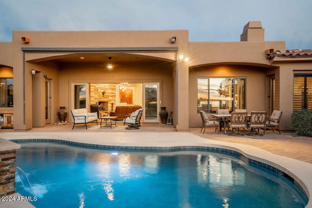 view of swimming pool with pool water feature and a patio area