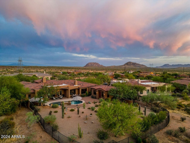 aerial view at dusk featuring a mountain view