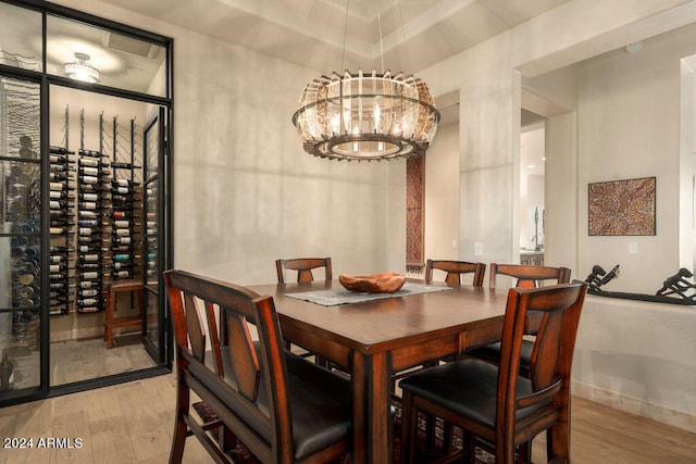 dining room featuring light hardwood / wood-style floors and a notable chandelier