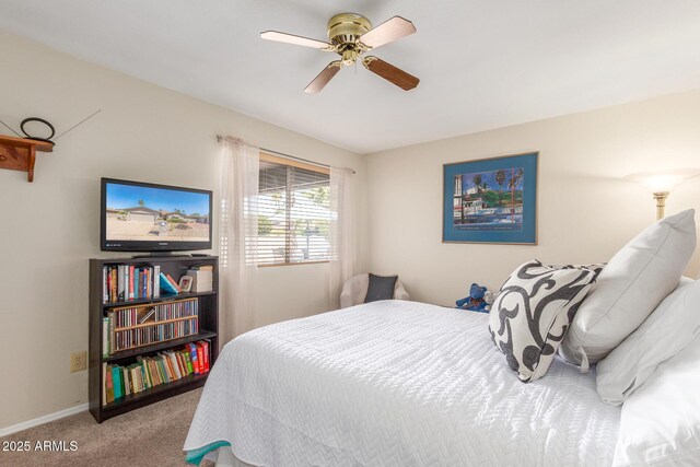 carpeted bedroom featuring baseboards and ceiling fan