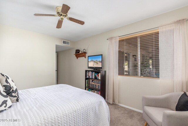 carpeted bedroom with visible vents, baseboards, and ceiling fan