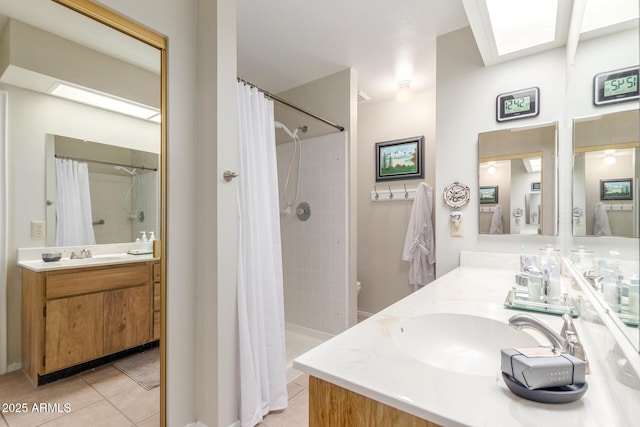 full bathroom with a sink, tiled shower, double vanity, and tile patterned floors