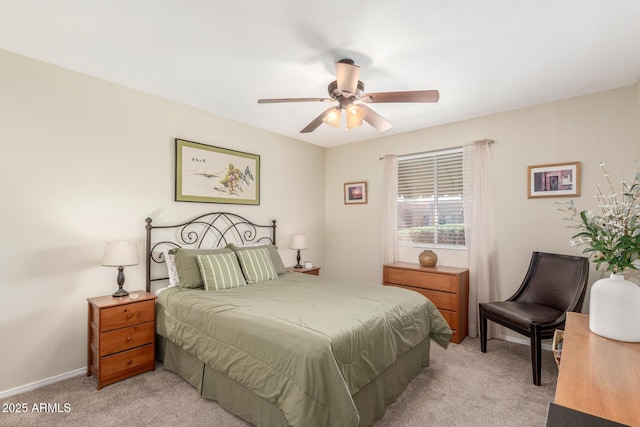 bedroom with light colored carpet, baseboards, and ceiling fan