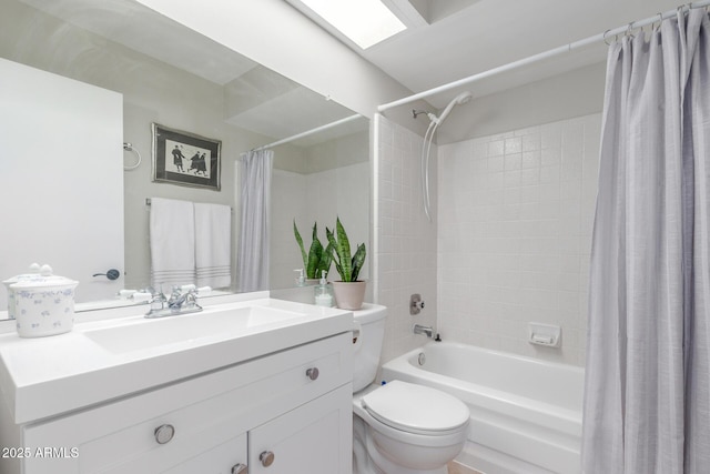 bathroom featuring vanity, a skylight, toilet, and shower / tub combo with curtain