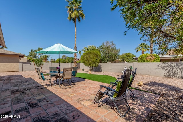 view of patio featuring a fenced backyard and outdoor dining space