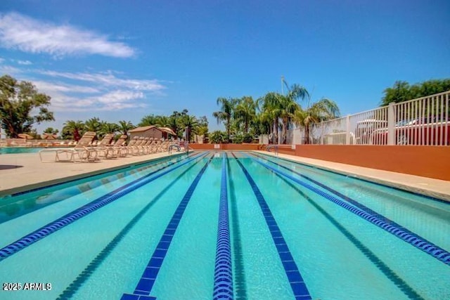 community pool featuring a patio and fence