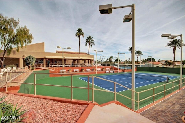 view of tennis court featuring fence