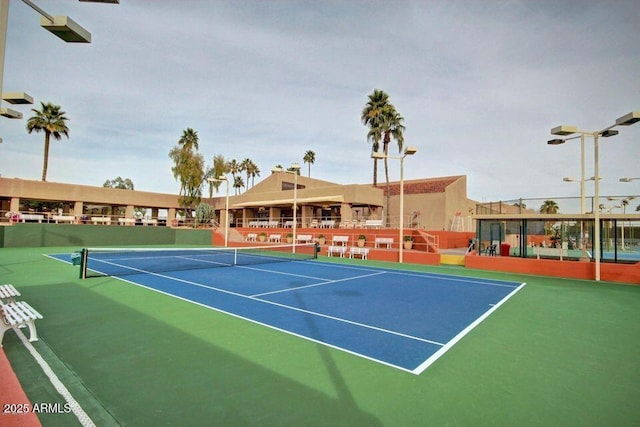 view of tennis court with fence