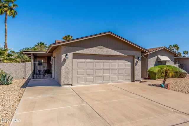 ranch-style house featuring stucco siding, driveway, a garage, and fence