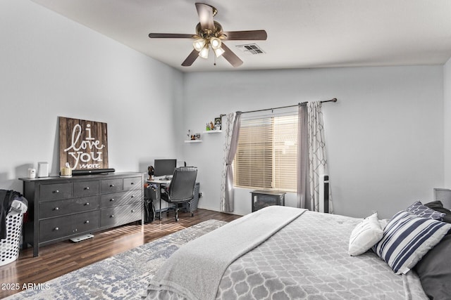 bedroom with dark hardwood / wood-style flooring, vaulted ceiling, and ceiling fan