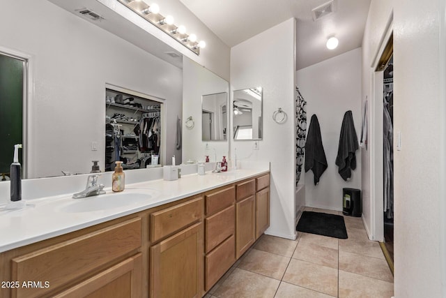 bathroom featuring tile patterned flooring, vanity, and ceiling fan