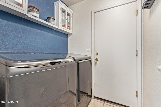 laundry room with light tile patterned flooring and separate washer and dryer