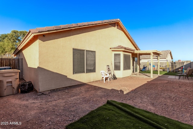 rear view of property featuring a patio