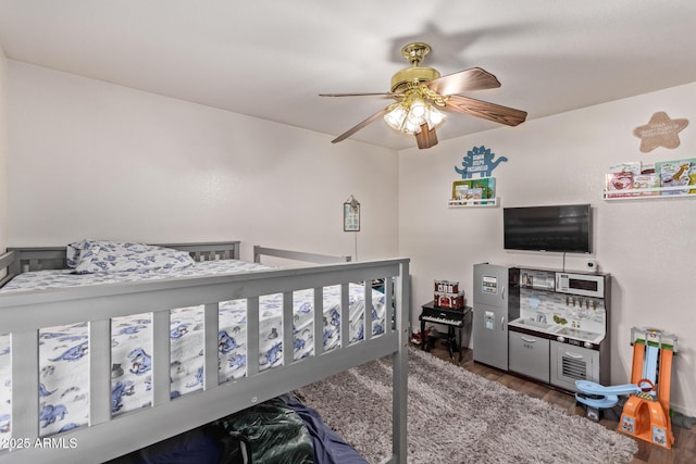 bedroom with dark hardwood / wood-style flooring and ceiling fan